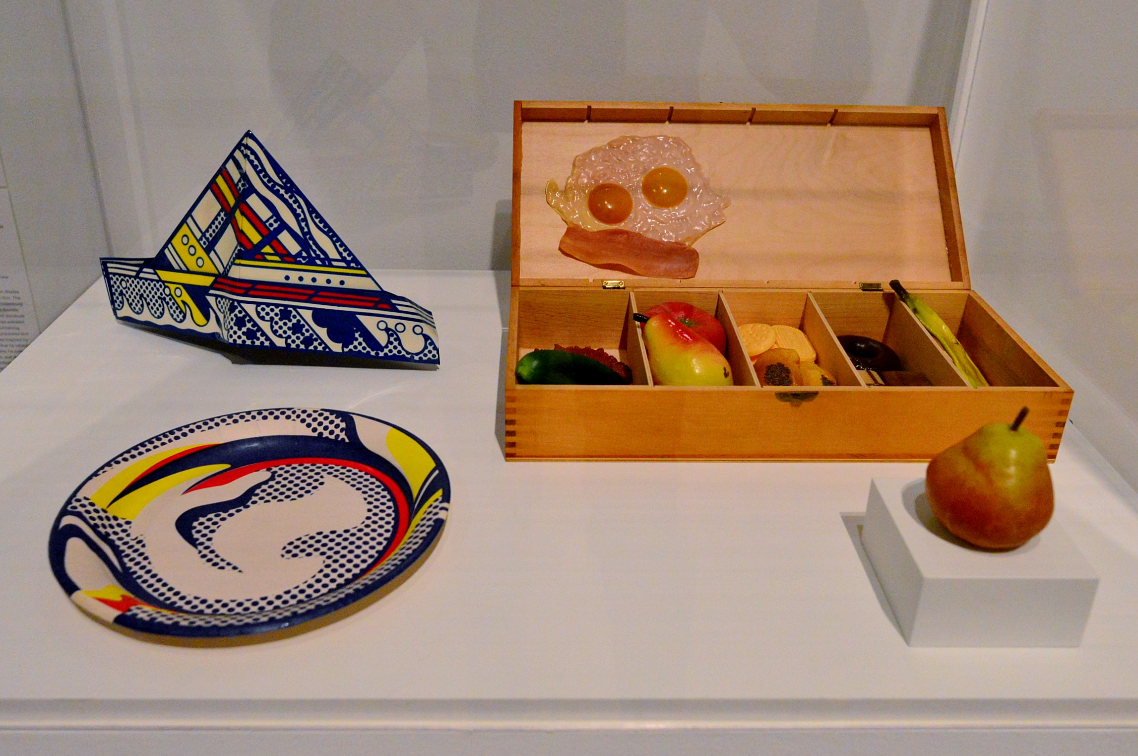 By Roy Lichtenstein (clockwise) Paper Plate and Folded Hat shown with False Food Selection and Pear by Claes Oldenburg.