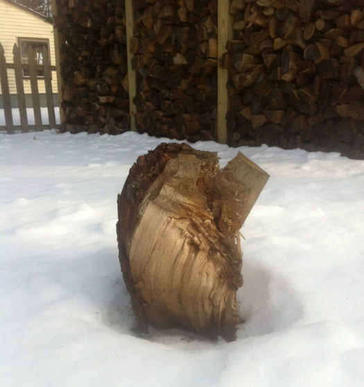 Outdoor sculpture and picture-perfect rack of firewood.