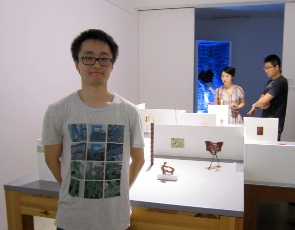 Artist with his piece in the Central Academy of Fine Arts student sculpture exhibition