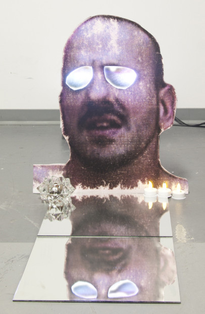 A HERMA (DEAD EYES OPENED), 2011, 42x36x36, Medium: Photographic print mounted on foamcore, video projector, DVD, LED candles, mirror, glass dish, coins
