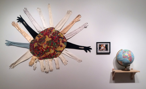 Beth Secor, You were, now are, the world of me, consists of embroidery of Alzheimer's MRI embellished with vintage kid and silk gloves (2013), photograph of Beth Secor standing, assisted by Shirley Secor, surrounded by Susan and Shirley Secor, mounted on found embroidered linen (1957), 12" repogle globe (1976-1991)