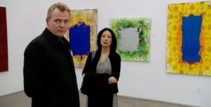 Actors Aidan Quinn and Lucy Liu in front of Mark Flood paintings. (Courtesy CBS)