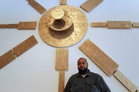Robert Pruitt in front of this past summer’s group exhibition "Coming Through The Gap in the Mountain on an Elephant" at TSU’s University Museum. Pruitt curated the show; Hodge was a participating artist. (Photo: James Nielsen/Houston Chronicle)