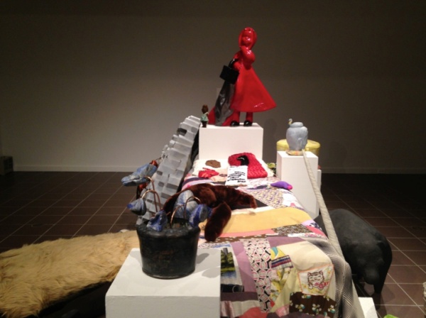 Wanderer (bed in center), 2004, fabric and objects on found quilt.