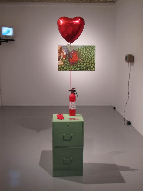 Installation view with Archival Science, 2014. flocked filing cabinet, grandmother's glove, 1984 coins, balloon, fire extinguisher.