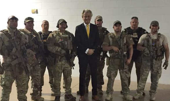 Wilders poses with Garland security. AP photo.