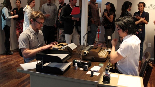 No Talking, Just Typing, 2010 (ongoing). Performance with two typewriters, microphone, electronics, office supplies; performed in San Antonio, Houston, and Honolulu; photo from 2014 performance at The Mariago Collective, Houston.