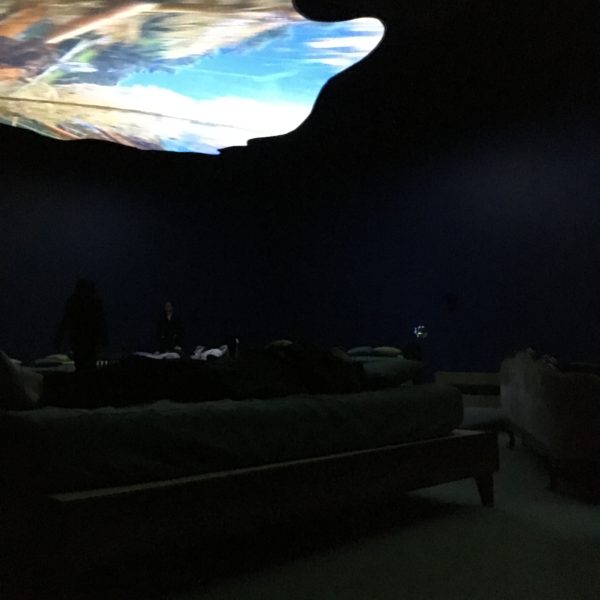 My friend Tere on a bed looking up at a 2016 video projection by Pipilotti Rist. 