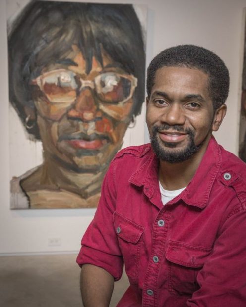 Sedrick Huckaby poses with a large painting of his mother, Ruthie Huckaby of Fort Worth, at the Valley House Gallery in Dallas, in 2013. (Ron Heflin/Special Contributor via Dallasnews.com)