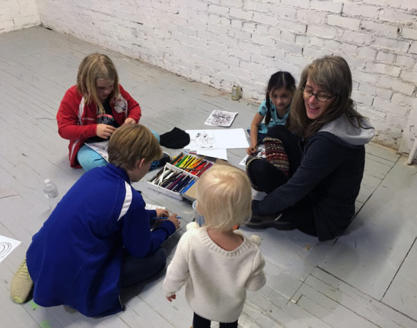 Kathryn Kelley playing drawing games with the local kids