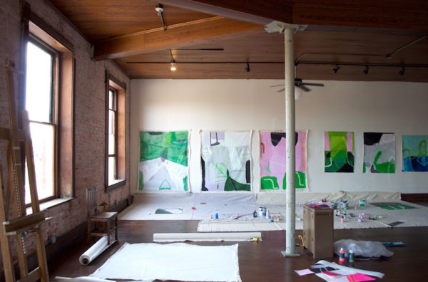Sarah Boyts Yoder Studio: The studio pictured here occupies much of the second floor. The paintings are the work of resident Sarah Boyts Yoder. Photo credit: Kyle Hobratschk.
