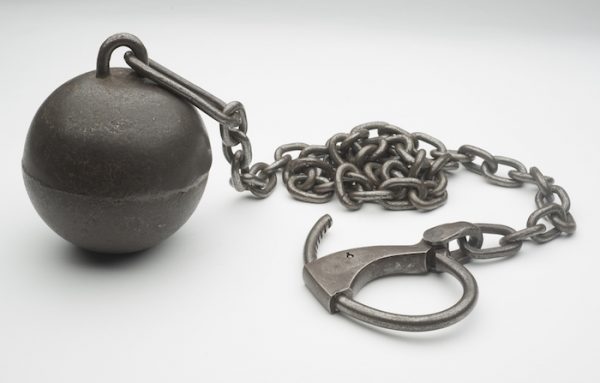 One of Harry Houdini's ball weights with ankle cuff. Photo by Pete Smith. Courtesy Harry Ransom Center.