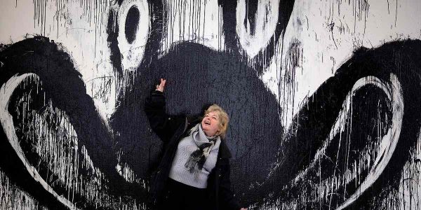 artist Joyce Pensato in front of one of her paintings
