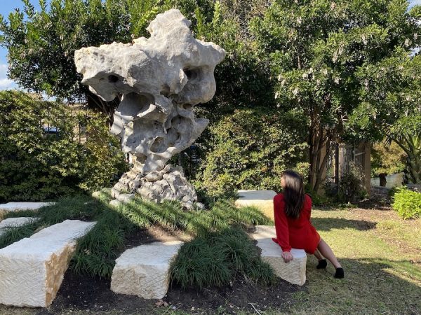 Taihu Rock contemplated by visitor, gray limestone with white veining and inclusions, 12 feet high, San Antonio Museum of Art.