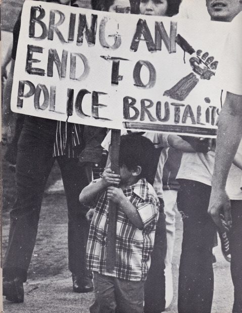 Child with sign at anti-police brutality demonstration in L.A., 1971