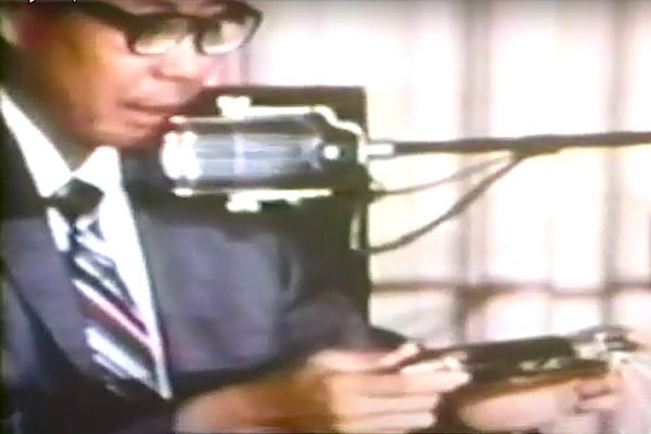 Deputy Coroner David Katsuyama with “Flite-Rite” tear gas projectile (a barricade penetrator not designed to be shot directly at people), testifying at Coroner’s Inquest, 1970. Katsuyama said Salazar’s head wound was consistent with the projectile.