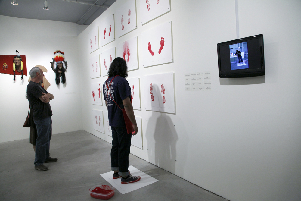 "Indian Standing In This Exact Spot Looking At Contemporary Native American Art II (performance still)." 2012. From Harjo's "Indian Performance Prints."