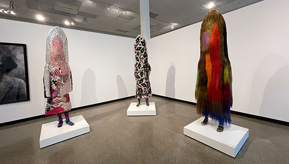 Nick Cave's Soundsuits at the entrance of 30 Americans at Arlington Museum of art