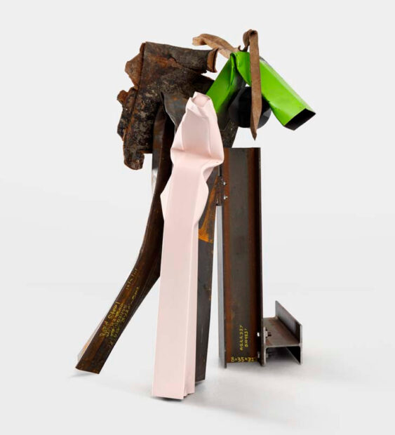 A sculpture by artist Carol Bove. The artwork features multiple metal pieces, some of which are painted green and light pink.