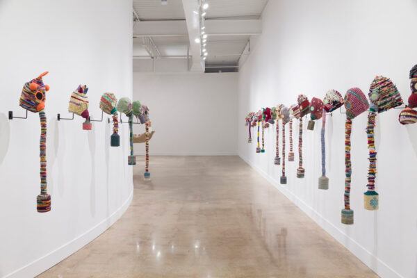 An installation view of an art show by Nomin Bold. Featuring a hallway of wall sculptures