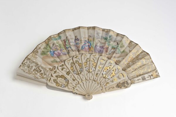 A hand held folding fan that contains a hand painted scene of multiple figures