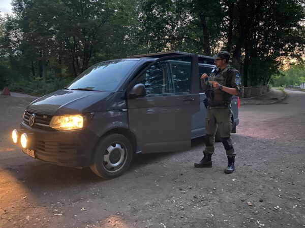 An Estonian Border Patrol officer standing by his vehicle