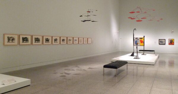 Exhibition view with works on paper, painting, sculpture and suspended mobiles by both Calder and Picasso