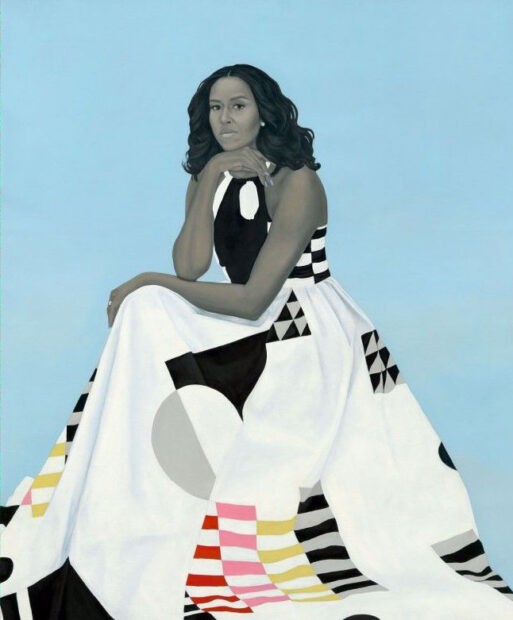 A painting of First Lady Michelle Obama. She wears a long flowing dress that is mostly white and has some sporadic patterns. Her skin is painted in grayscale and contrasts against the plain light blue background and the pops of red, pink, and yellow in the patterning of the dress. Portrait by Amy Sherald.