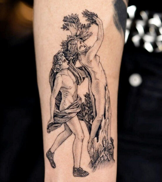 A tattoo of Apollo chasing Daphne while she converts to a laurel tree