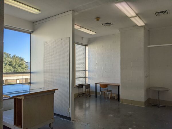 A photograph of a studio space with concrete floors and white walls. The space is at the Art Fort Worth building.