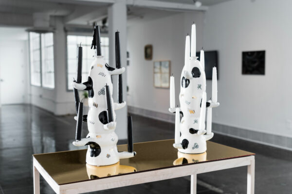 Sculptural work by artist Jennifer Ling Datchuk of oddly shaped white and black porcelain candle holders