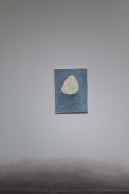 A gestural and abstract painting of a yellow and green rock