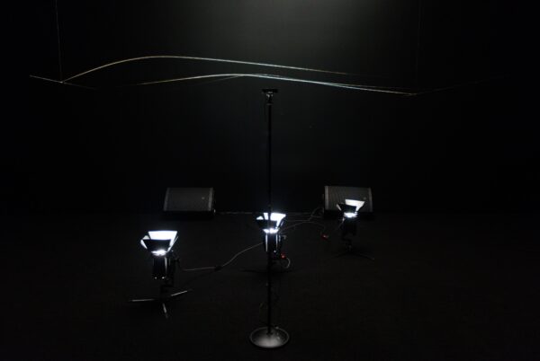 Exhibition image of a work that plays light with sound in the air