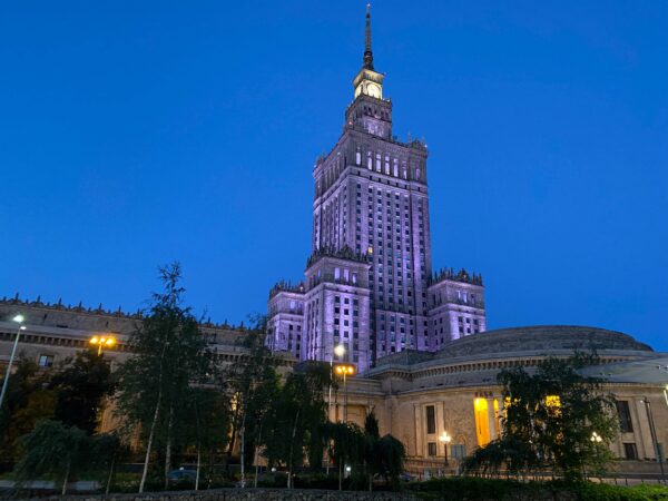 A photo of the Warsaw Palace of Culture and Science lit up at night