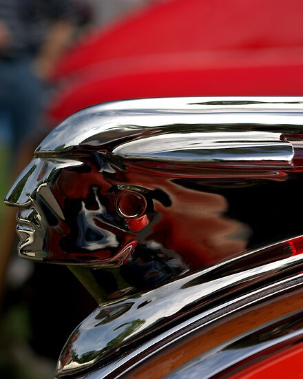 Detail of a Pontiac hood ornament that shows a sleek and stylized head and face