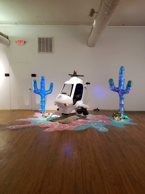 A miniature ICE helicopter with bright plastic cacti on either side