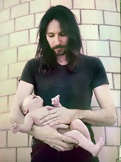 Image of the author holding his newborn son Max