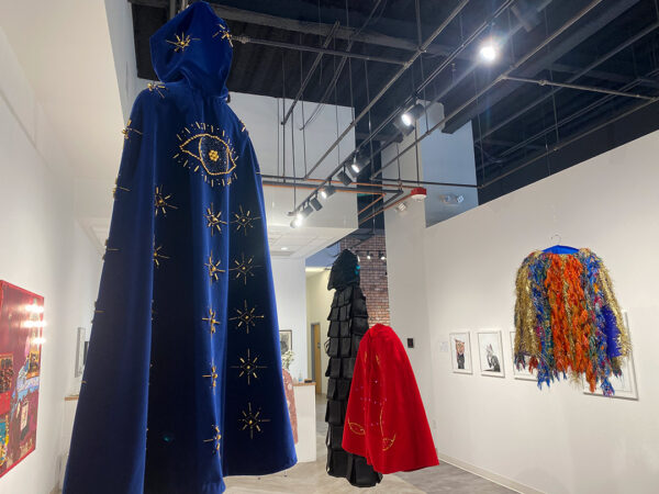 A photograph of four capes created by Krissy Teegerstrom.