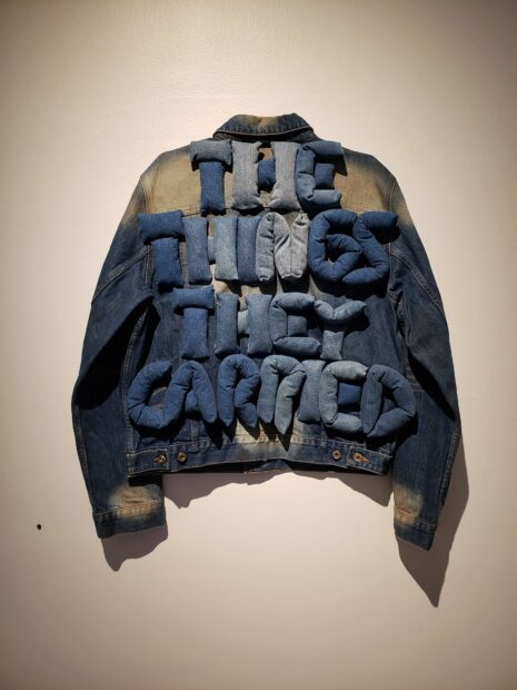 Denim jacket with the words "The things they carried" in fabric puff letters across the back