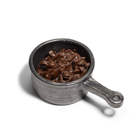 A pan containting with brown, chocolate-looking frogs.