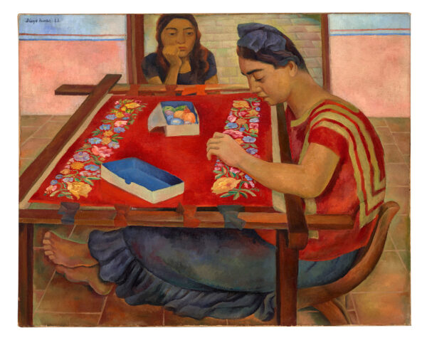 A painting by Diego Rivera that features two women sitting at a large rectangular table used to work on embroidery. One woman works on a floral pattern while the other woman looks on. 