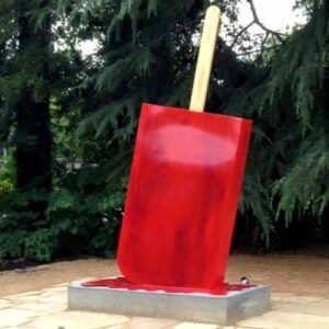 A sculpture of a paleta by David Blancas. The sculpture is of a red overturned paleta that appears to be melting.