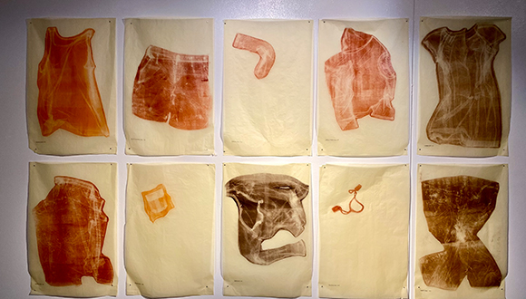ten works on paper with impressions of articles of clothing and personal items left by the undocumented