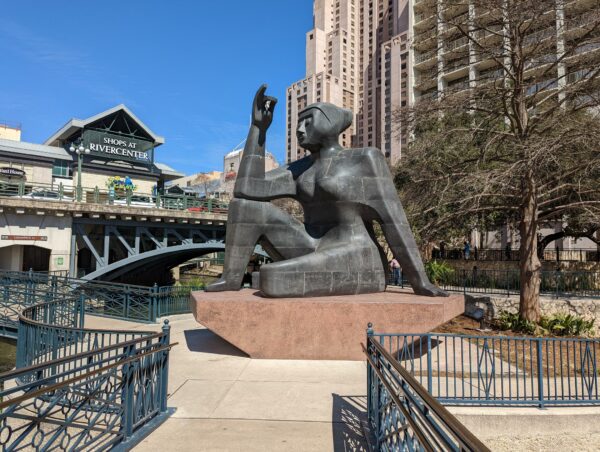 A photograph of Pedro Reyes' "Stargazer (Citlali)." The 16-foot tall sculpture sits on a 5-foot tall base overlooking the River Walk in San Antonio. 