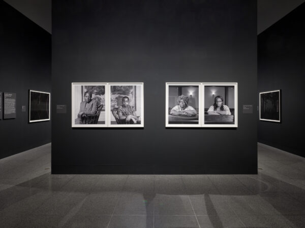 Installation image of photos on a wall at the MFA Houston