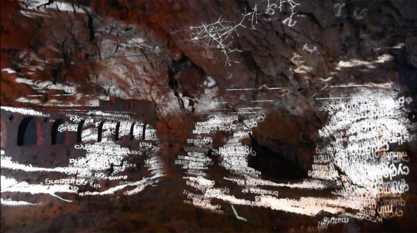 A still image from a video projection titled, "A Simple History," at Lazaret Cave.
