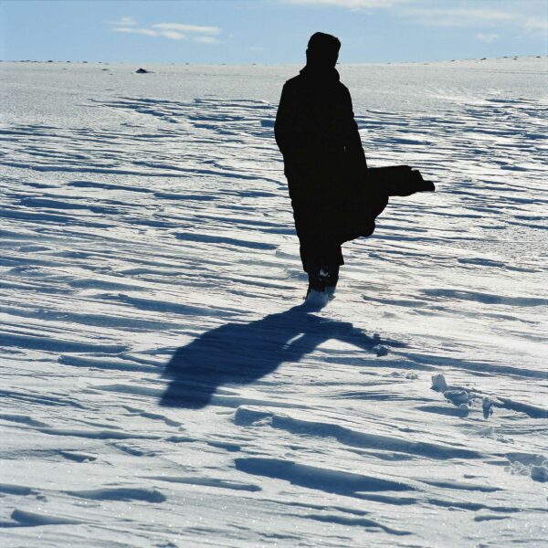 Image of a person walking through a snowy landscape