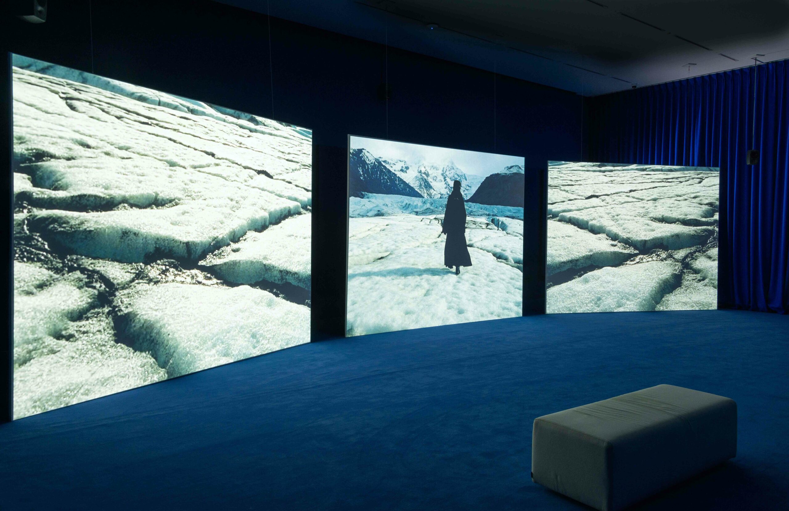 Installation view of a large3 three channel video piece