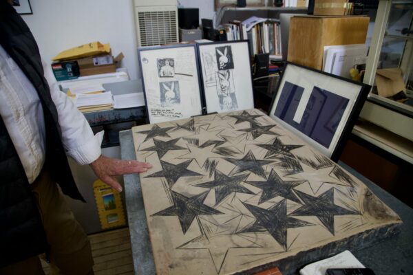 A photograph of a 100-year-old lithograph stone with a grease pencil drawing of five-pointed stars.
