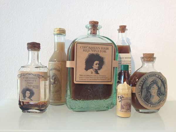 Bottles of liquid with images of women with large, textured hair